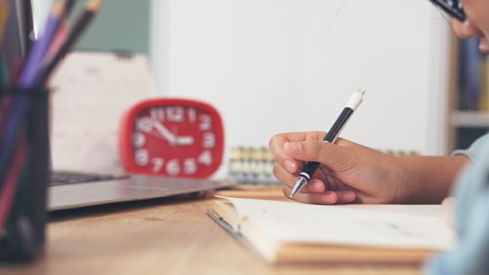 Student writing in her notebook