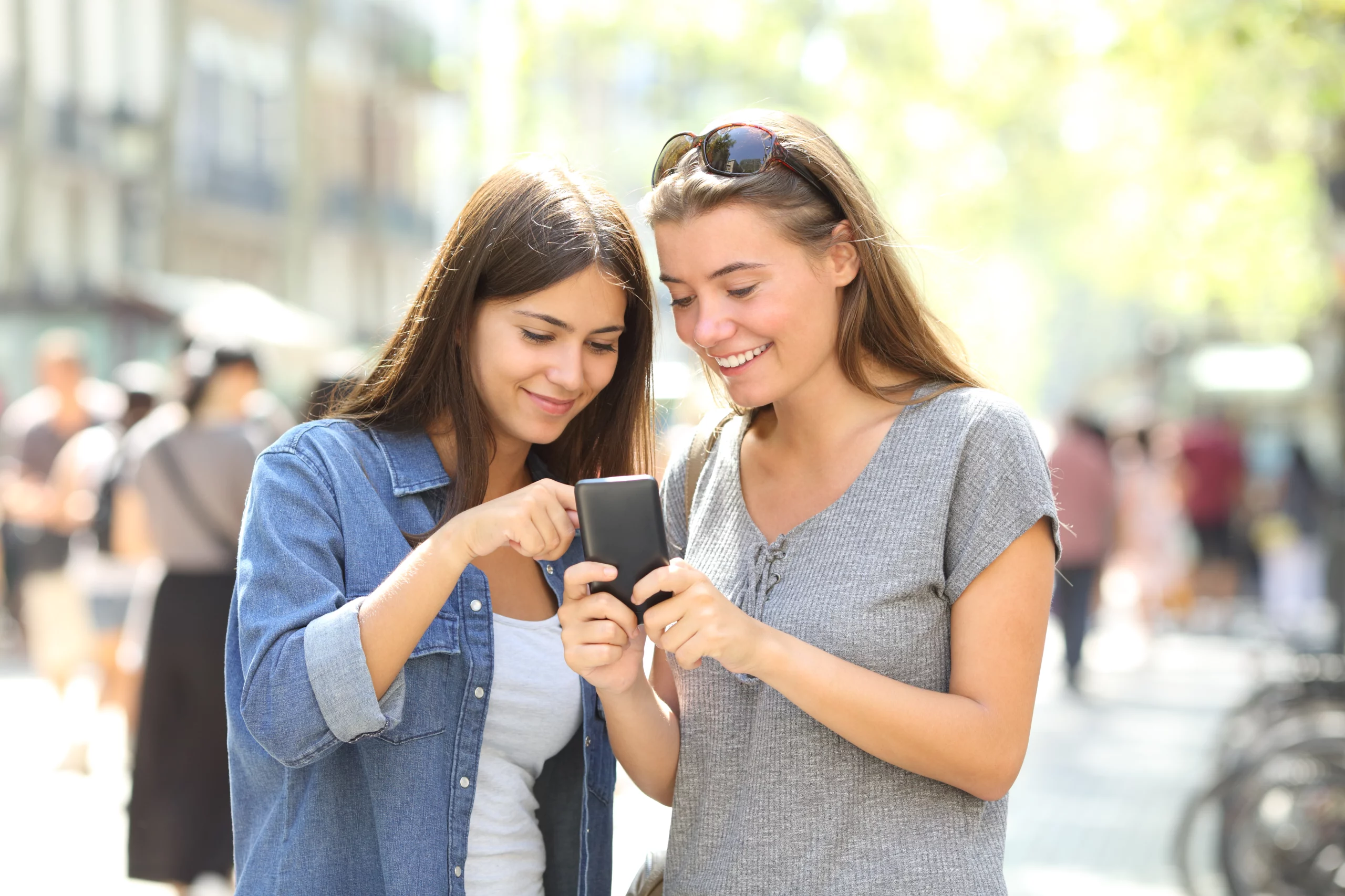 two women looking at a phone