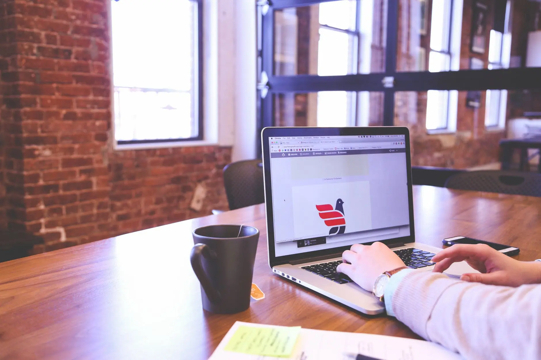 a laptop showing someone who is working on logo creation