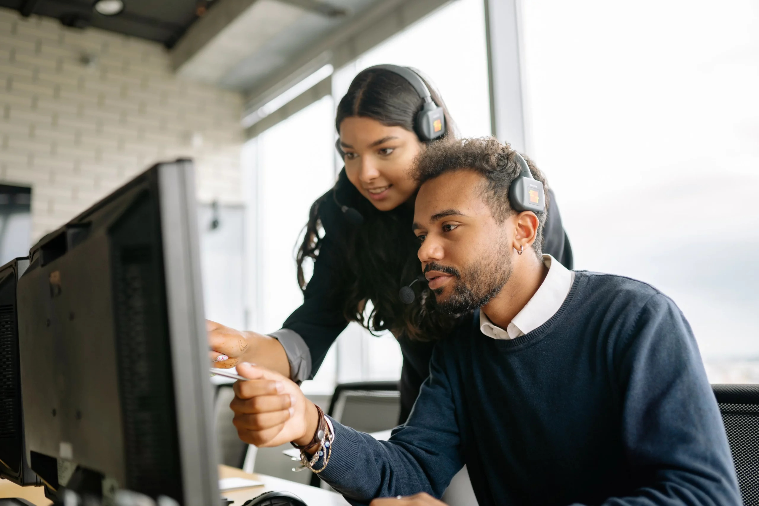 two people looking at a computer together