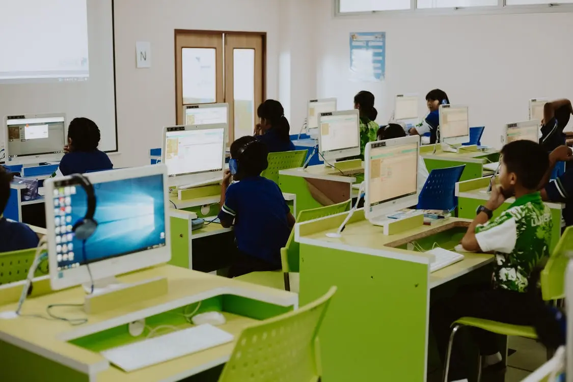 high school students on laptops using simulations