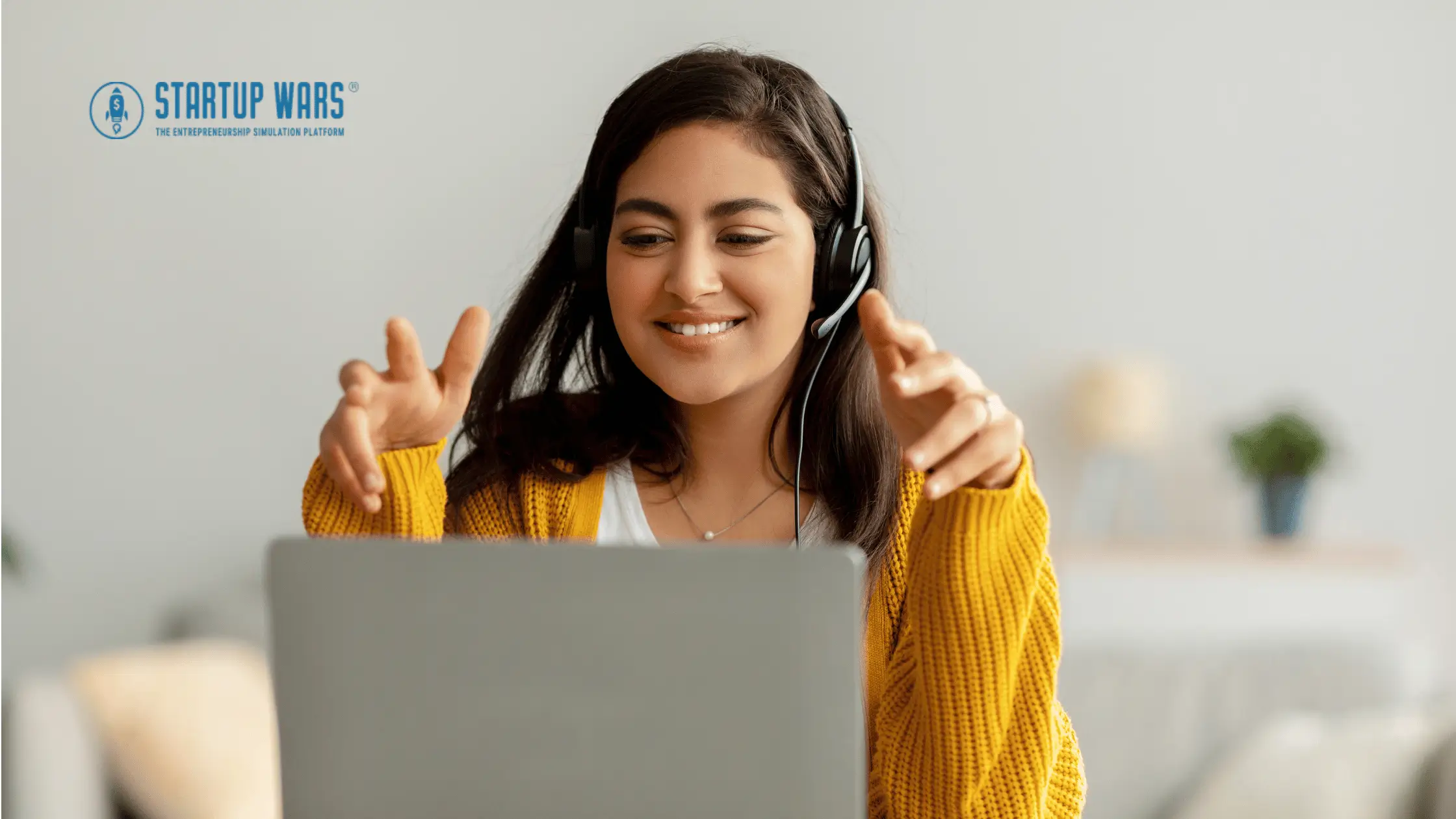 Female student participating in a business simulation game on a laptop, wearing headphones, and smiling while interacting with virtual enterprise environments.